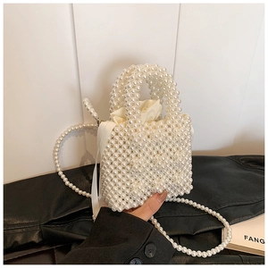 Detail of handmade pearl woven handbag with satin drawstring inner and shoulder strap