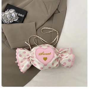 Detail of candy-shaped crossbody bag with sweet heart embroidery and chain strap