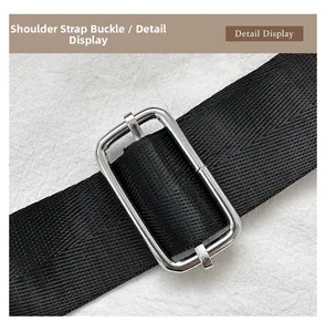 Detail of adjustable black woven strap with silver metal buckle on guitar shaped bag