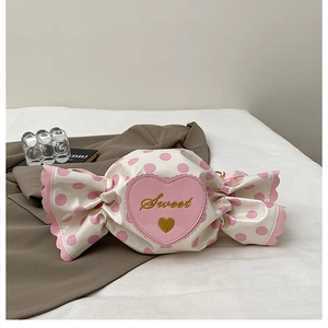 Detail of candy-shaped bag featuring pink polka dots and embroidered Sweet heart patch
