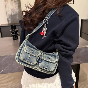 Vintage washed denim shoulder bag with utility pockets and heart pendant decoration