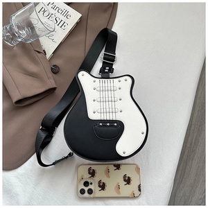 Detail of creative guitar-shaped crossbody bag with rivets and adjustable strap