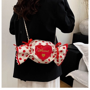 Detail of candy-shaped crossbody bag with red polka dots and Sweet heart embroidery