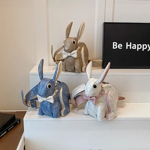 Cute bunny shaped crossbody bags in gold, blue, and white with textured matte finish