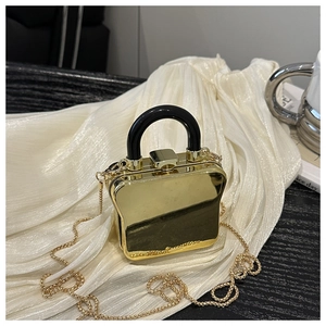 Detailed view of luxury gold toast-shaped acrylic clutch bag with metal handle and chain
