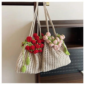 Detailed close-up of handmade crochet tote bags with 3D red and pink rose floral accents