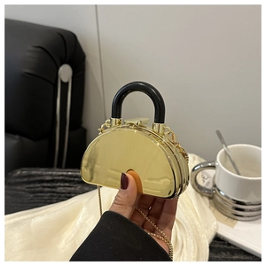 Detailed view of mini gold mirror acrylic box bag with black handle and chain strap