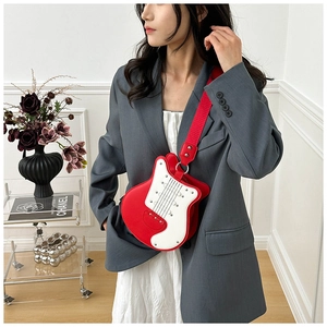 Chic guitar shaped crossbody bag in red and white with studded details and wide strap