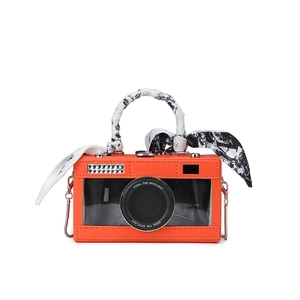 Vintage orange camera-shaped box bag with a patterned scarf handle and chain strap