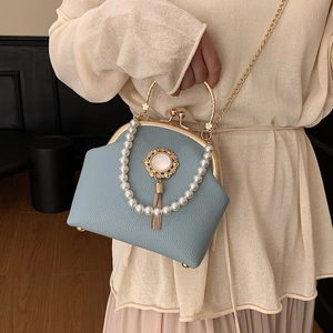 Light blue faux leather shell bag with pearl handle and vintage gold tassel emblem