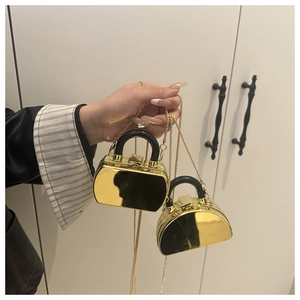 Close-up of golden metallic mirror mini lipstick bags with snap closure and chain strap