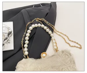 Close-up of elegant floral chiffon texture with pearl handle and golden chain details