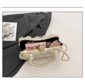 Detailed internal view showing the capacity of this elegant cream lace evening bag