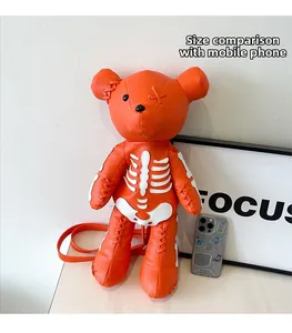 Detail of orange skeleton bear bag showing size compared to a smartphone device