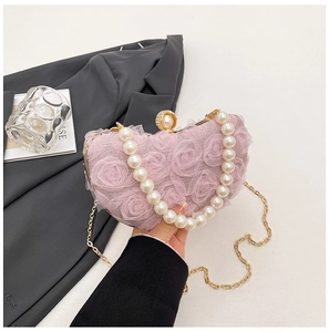 Detail of pink floral evening bag with pearl handle and detachable gold chain strap