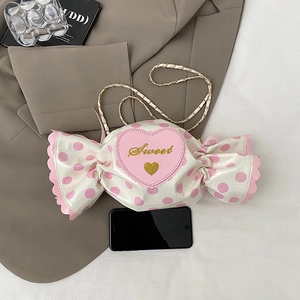 Cute candy-shaped shoulder bag with pink polka dots and golden Sweet embroidery detail