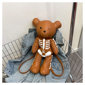 Close-up of skeleton teddy bear backpack showing lychee texture leather and hand-stitched details