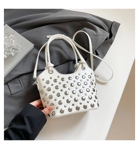 Detailed view of white PU bucket bag with silver studs and versatile shoulder straps