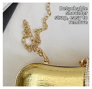 Detail of gold evening bag with rhinestones and detachable metal chain strap