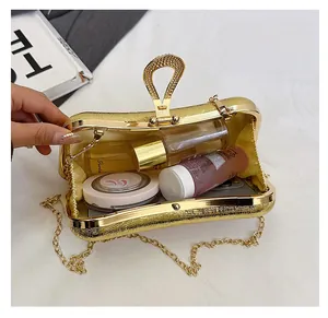 Macro detail of gold textured evening clutch bag showing its spacious inner capacity