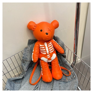 Detail of orange bear backpack with white skeleton print and stitching on lychee leather