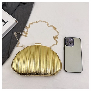 Golden pleated evening clutch with chain strap shown beside a phone for size reference