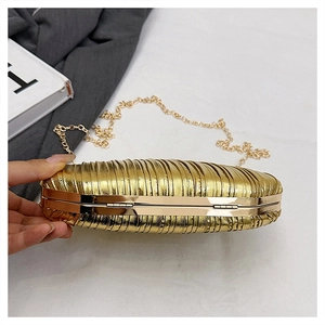 Detailed view of golden pleated evening clutch with elegant metallic texture and fine chain