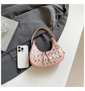 Pink crescent hobo bag with silver rivets and double zipper on a sleek backdrop