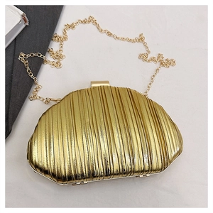 Close-up of golden pleated evening clutch bag with metallic finish and chain strap