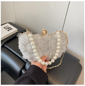 Detailed view of white lace rose flower evening bag with pearl handle and diamond clasp