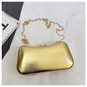 Top view of gold textured hard-shell evening clutch bag with sleek metal chain strap