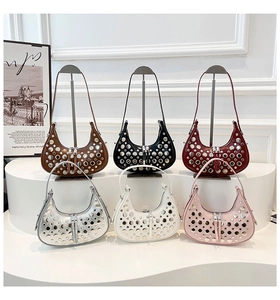 Detailed shot of various colored bucket bags with silver rivets and dual zipper closure
