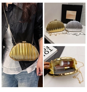 Detailed interior view of pleated shell-shaped evening bag in gold and silver finish