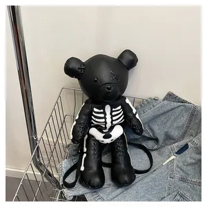 Detail view of cartoon bear backpack with white skeleton print on black lychee leather