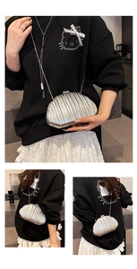 Detailed views of silver pleated shell bag with metallic finish and metal chain strap