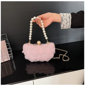 Detail of pink lace rose evening bag with pearl handle and sparkling crystal clasp