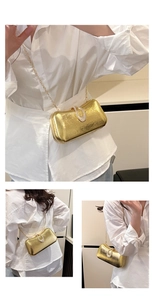 Detail of elegant gold evening bag with rhinestone buckle and fine chain strap