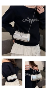 Detailed macro view of a silver clutch bag with sparkling texture and rhinestone buckle