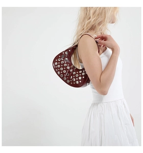 Fashionable burgundy crescent underarm bag with silver rivets and polished finish