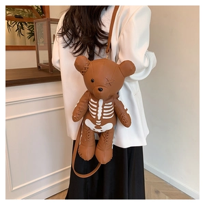 Detailed back view of a brown bear shaped backpack with white skeleton embroidery design