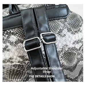 Detail of adjustable black strap with silver metal buckle on faux snakeskin backpack