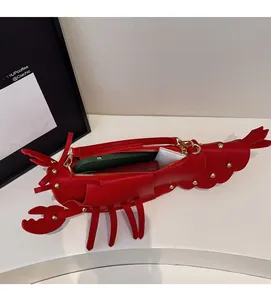 Detail view of the spacious interior of a red lobster-shaped bag with gold rivets