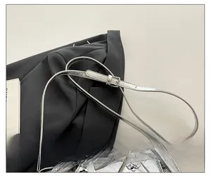 Macro shot of adjustable leather shoulder strap with silver metal buckle on silver bag