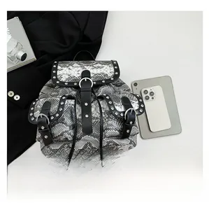 Macro view of snakeskin print backpack with silver rivet studs and black buckle details
