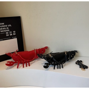 Detailed view of creative lobster-shaped crossbody bags with rivets and gold zippers