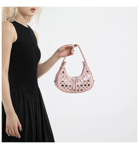 Detailed shot of a pink hobo bag with silver metallic rivets and zipper closure