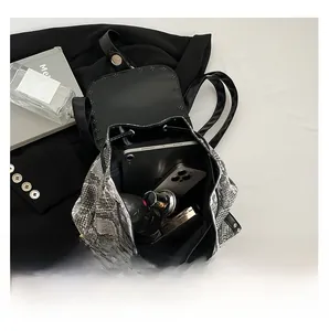 Top view of large capacity faux leather backpack showing spacious interior with daily items