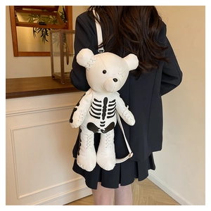 Detail of white bear backpack featuring black ribcage print and cross-stitched seams