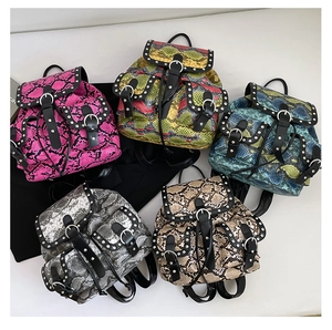 Detailed display of five snakeskin pattern backpacks with rivets and metallic buckles