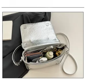 Silver foil textured crossbody bag showing internal capacity for daily essentials